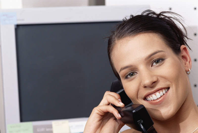 woman on phone by computer